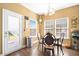 Bright dining area with chandelier lighting and a view to the backyard patio at 112 Worthington Dr, Moncks Corner, SC 29461