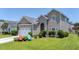 Charming two-story home features a well-maintained lawn, inviting entrance, and attached garage at 112 Worthington Dr, Moncks Corner, SC 29461