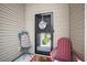 Close-up of the home's inviting front door, featuring a charming wreath and a cozy chair at 112 Worthington Dr, Moncks Corner, SC 29461