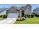 Charming two-story home with a well-manicured lawn and a two-car garage at 112 Worthington Dr, Moncks Corner, SC 29461