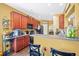 Well-lit kitchen with cherry cabinets and seating at a kitchen island at 112 Worthington Dr, Moncks Corner, SC 29461