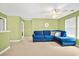 Inviting living room with a plush blue sofa, lots of natural light, and neutral carpet at 112 Worthington Dr, Moncks Corner, SC 29461