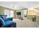 Inviting living room with a plush blue sofa, lots of natural light, and neutral carpet at 112 Worthington Dr, Moncks Corner, SC 29461