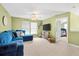 Inviting living room with plush blue sofa, lots of natural light, and neutral carpet at 112 Worthington Dr, Moncks Corner, SC 29461