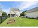Landscaped backyard with raised garden beds and screened in porch at 123 Gaslight Blvd, Summerville, SC 29483