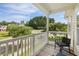 Private balcony with a railing and a peaceful neighborhood view from the wooden deck at 123 Gaslight Blvd, Summerville, SC 29483