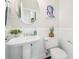 Well-lit half bath with white wainscoting, a pedestal sink, and modern decor at 123 Gaslight Blvd, Summerville, SC 29483
