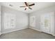Bright bedroom with ample natural light features carpet floors, a ceiling fan, and a door that opens to a balcony at 123 Gaslight Blvd, Summerville, SC 29483