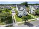 Well-manicured yard of a two-story home, palm trees, and a detached garage in the surrounding area at 123 Gaslight Blvd, Summerville, SC 29483
