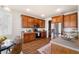 Well-lit kitchen with brown cabinets, stainless steel appliances, and an adjacent breakfast nook at 123 Gaslight Blvd, Summerville, SC 29483