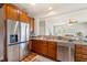 Modern kitchen equipped with stainless steel appliances, brown cabinets, and an open layout at 123 Gaslight Blvd, Summerville, SC 29483