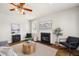 Bright living room featuring a fireplace, ceiling fan, hardwood floors, and comfortable seating at 123 Gaslight Blvd, Summerville, SC 29483