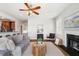 Comfortable living room featuring a fireplace, ceiling fan, and hardwood floors at 123 Gaslight Blvd, Summerville, SC 29483