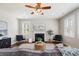 Bright living room features a fireplace, ceiling fan, hardwood floors, and comfortable seating at 123 Gaslight Blvd, Summerville, SC 29483