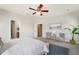 Bright main bedroom features neutral walls, ceiling fan, seating area, and ensuite bathroom at 123 Gaslight Blvd, Summerville, SC 29483