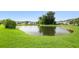 View of a well maintained pond with green grass at 123 Gaslight Blvd, Summerville, SC 29483