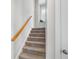 Carpeted staircase with wooden handrail leads to a window seat with natural light, creating a cozy and inviting space at 123 Gaslight Blvd, Summerville, SC 29483