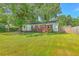 Lush backyard with expansive lawn, mature shade tree, and well-maintained perimeter fencing at 131 Harvey Ave, Goose Creek, SC 29445