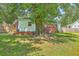 Backyard view of home featuring a beautiful lawn, mature tree, and partial fence at 131 Harvey Ave, Goose Creek, SC 29445