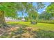 Spacious backyard with mature shade tree and outdoor seating provides a tranquil retreat at 131 Harvey Ave, Goose Creek, SC 29445
