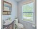 Charming bathroom with wooden vanity, mirror, and natural light at 131 Harvey Ave, Goose Creek, SC 29445
