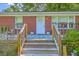 Close-up of front porch, showcasing the welcoming entrance with a wooden deck and a vibrant blue rug at 131 Harvey Ave, Goose Creek, SC 29445