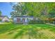 Charming brick home with a well-manicured lawn and inviting front porch, perfect for enjoying the outdoors at 131 Harvey Ave, Goose Creek, SC 29445