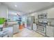 Open-concept kitchen flows to office with stainless appliances and gray cabinetry at 131 Harvey Ave, Goose Creek, SC 29445