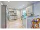 Well-lit kitchen with gray cabinets, stainless steel appliances, and stylish bar seating at 131 Harvey Ave, Goose Creek, SC 29445