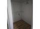 This empty closet has neutral paint, shelving for storage, and modern vinyl plank flooring at 1346 Ellison Run, Charleston, SC 29412