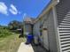 Back exterior view of the home, with vinyl siding, an outdoor AC unit, and mature trees at 1346 Ellison Run, Charleston, SC 29412