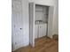 Convenient laundry closet with a washer and dryer situated off of a room with wood floors at 1346 Ellison Run, Charleston, SC 29412