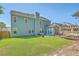 Expansive backyard with lush lawn, patio, outdoor kitchen, and pergola at 139 Back Tee Cir, Summerville, SC 29485