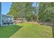 Expansive backyard featuring a deck with pergola, lush green lawn, and a wooded backdrop for privacy at 139 Back Tee Cir, Summerville, SC 29485