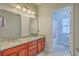 Bathroom featuring double sinks, granite countertops, wood cabinets, tile floors, and tub/shower combo at 139 Back Tee Cir, Summerville, SC 29485