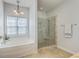 Bathroom featuring a tub, a glass-enclosed shower, and a chandelier-style light fixture at 139 Back Tee Cir, Summerville, SC 29485