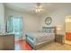 Bedroom with wood floors, neutral walls, double window, and view into the bathroom at 139 Back Tee Cir, Summerville, SC 29485