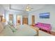 Bright, spacious bedroom with tray ceiling, wood floors, area rug, and stylish pink sofa at 139 Back Tee Cir, Summerville, SC 29485