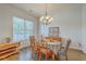 Elegant dining area featuring a classic chandelier, wood floors, and natural light from a window at 139 Back Tee Cir, Summerville, SC 29485