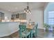 Cozy dining room featuring a rustic wooden table, turquoise chairs, and stylish industrial pendant lighting at 139 Back Tee Cir, Summerville, SC 29485
