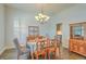 Bright dining room with chandelier, wooden furniture, and decor for a cozy ambiance at 139 Back Tee Cir, Summerville, SC 29485