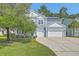 Charming two-story home with light blue siding, a well-manicured lawn, and a two-car garage at 139 Back Tee Cir, Summerville, SC 29485