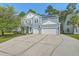 Two-story home featuring a two-car garage, light blue siding and a spacious driveway at 139 Back Tee Cir, Summerville, SC 29485