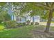 Attractive two-story house featuring light blue siding, a front porch, and a well-maintained lawn and landscaping at 139 Back Tee Cir, Summerville, SC 29485