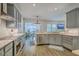 Open kitchen with stainless steel appliances and view to dining area and comfortable living room at 139 Back Tee Cir, Summerville, SC 29485
