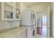 Well-organized laundry room with stacked washer/dryer and storage cabinets at 139 Back Tee Cir, Summerville, SC 29485
