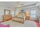 Spacious primary bedroom features a tray ceiling, ceiling fan, and complete wooden bedroom set at 139 Back Tee Cir, Summerville, SC 29485