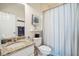 Cozy bathroom featuring granite countertop, vanity, and a blue-striped shower curtain at 1621 Folly Creek Way # D-8, Charleston, SC 29412