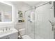 Stylish bathroom featuring a glass shower, modern lighting, sleek vanity, and decorative shelving at 1621 Folly Creek Way # D-8, Charleston, SC 29412