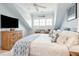 This bedroom has slanted ceilings, built-in storage, a ceiling fan, and a large window with natural light at 1621 Folly Creek Way # D-8, Charleston, SC 29412